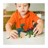 Child playing with dinosaur toys