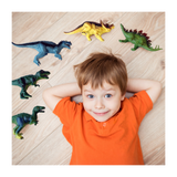 Child lying on floor with dinosaur toys